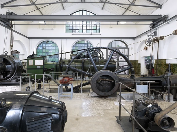 Historic machine hall at the Großauheim Museum, featuring large flywheels and engines
