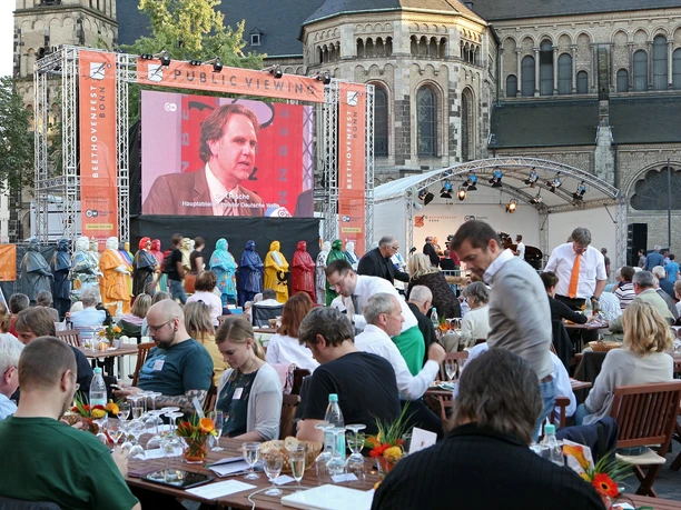 Beethoven Festival with a stage, screen, and audience in front of a historic church
