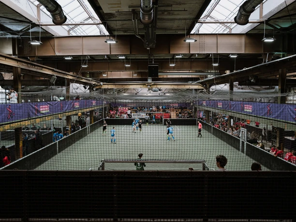 Come Together Cup at BASE Street Soccer Indoor soccer game at the Strassenkicker Base with spectators behind nets