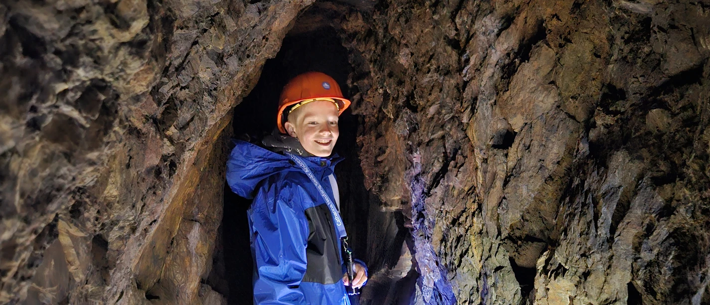 Guest at Catharina Neufang's A child wearing a helmet in a narrow mine tunnel at the Catharina Neufang Mine.