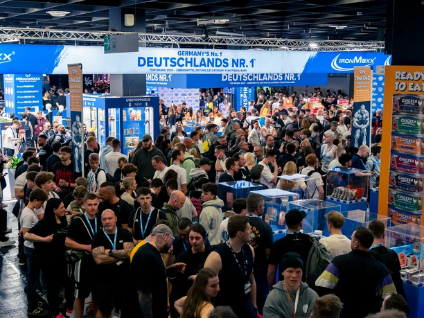 FIBO in Cologne A bustling FIBO exhibition hall filled with visitors and sports nutrition booths