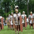 Internationale Römer- und Germanentage in Kalkriese Men in Roman armor at a historical re-enactment in the countryside.
