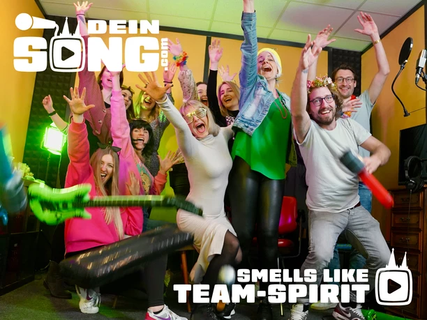 deinsong.com - Smells Like Teen Spirit! A cheering group in a recording studio with a microphone, props, and the deinSONG logo