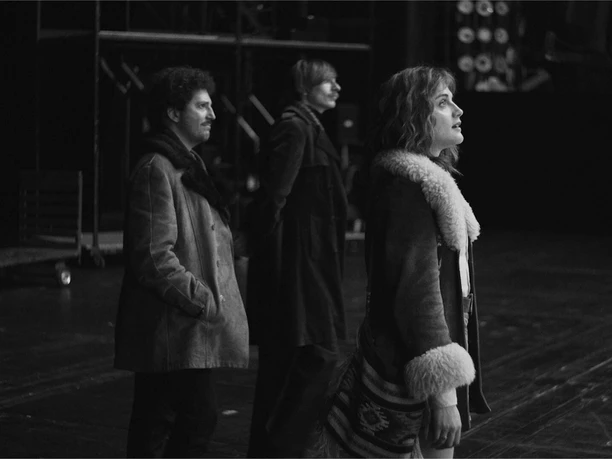 "Köln 75," a feature film about Keith Jarrett's legendary "Cologne Concert," Germany / Austria / Poland, 2024 A black-and-white film scene featuring three people on a dark stage