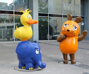 Mouse, Elephant, and Duck in front of the WDR Cologne building A mouse, an elephant, and a duck as colorful figures in front of the WDR building in Cologne