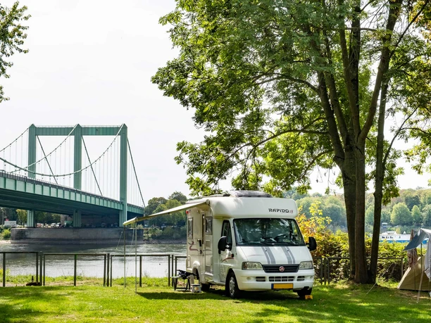 Stadt Köln Campsite RV and tent at the campground on the Rhine with a view of the Rodenkirchen Bridge in Cologne