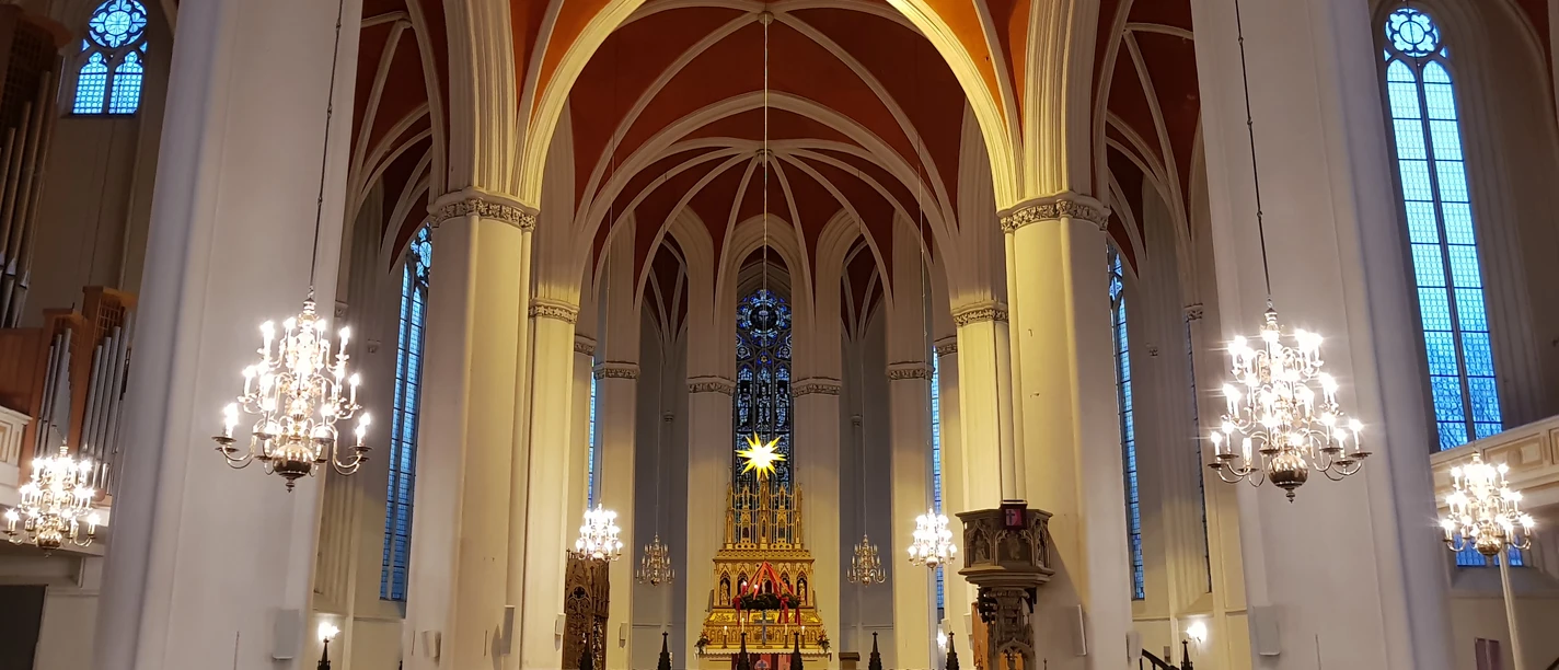 Verden Cathedral Verden Cathedral, decorated for Christmas with a star, an altar, chandeliers, and a crowd.