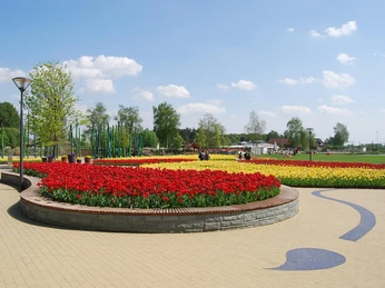 Gartenschaupark Rietberg Eingangsbereich Eingangsbereich des Gartenschauparks Rietberg mit bunten Blumenbeeten und Spazierwegen im Sonnenschein.