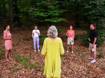 Heilklima-Wandern in Bad Lippspringe Gruppe von fünf Personen bei einer Achtsamkeitsübung im Wald von Bad Lippspringe.