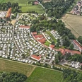 Campotel Bad Rothenfelde Luftaufnahme eines weitläufigen Campingplatzes mit zahlreichen Wohnwagen und umgeben von Wäldern und Feldern.