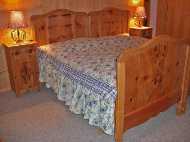 Wooden double bed in a bedroom