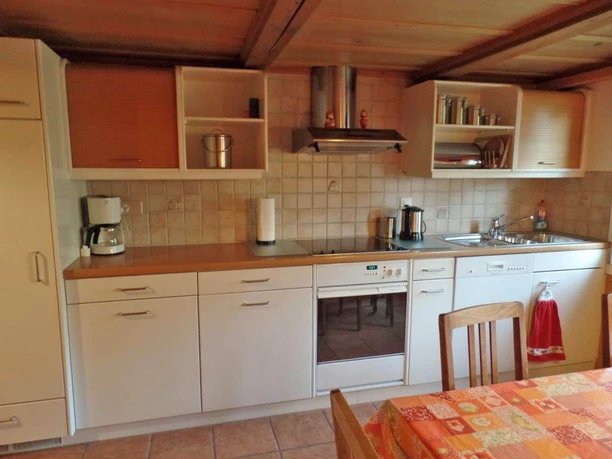 Cuisine dans l'appartement de vacances au Chalet Grimmialp Cuisine équipée avec table à manger