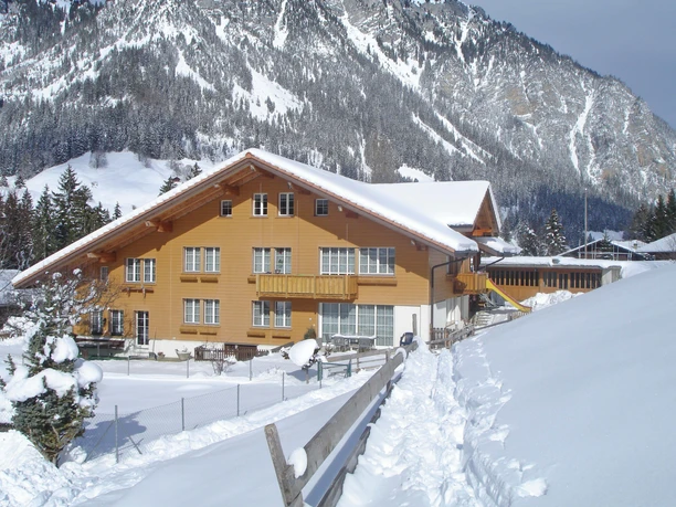 Chalet in a snow-covered mountain landscape
