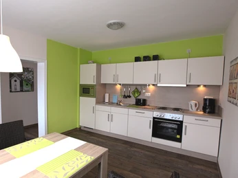 Wohnküche der Ferienwohnung Sprekels Wohnküche der Ferienwohnung SprekelsKitchen-living room of the Sprekels vacation apartmentKøkken-stue i Sprekels-ferielejlighedenKeuken-woonkamer van het Sprekels appartement