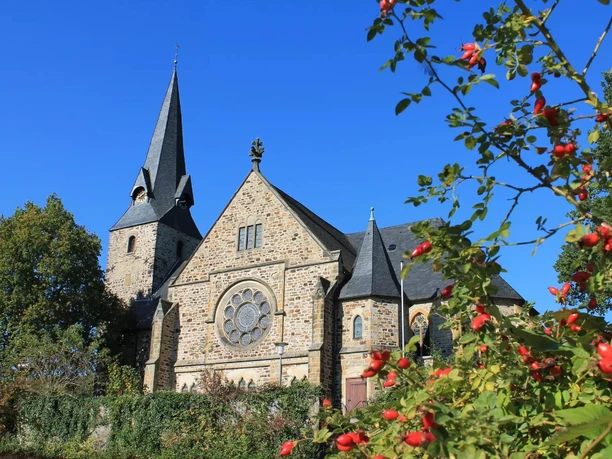 Evangelisch-Lutherische Bartholomäuskirche Evangelisch-Lutherische Bartholomäuskirche mit spitzem Turm und Ziegelsteinfassade vor blauem Himmel.