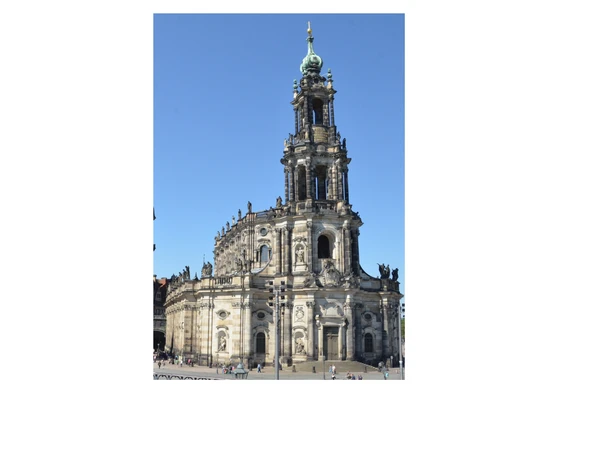 Catholic Court Church in Dresden with baroque façade and striking tower against a blue sky.