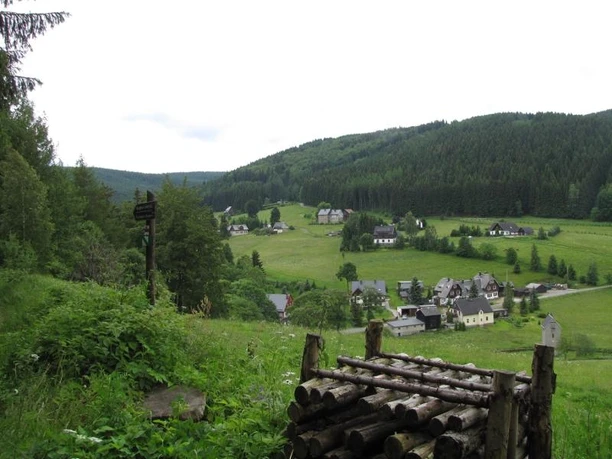 Rural view of Rittersgrün with scattered houses in a wooded hilly landscape.