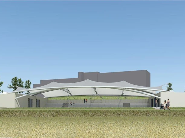 Modern open-air arena with stone grandstand, covered by an elegant white membrane roof.