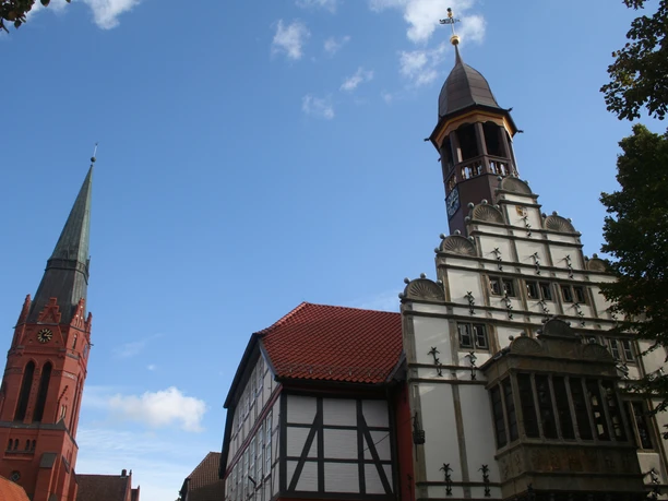 Rathaus und Kirche Nienburg Historic buildings in Nienburg on a sunny day with blue sky and scattered clouds.