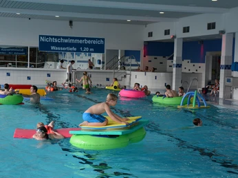 Familienfreundliches Hallenbad in Brakel mit Nichtschwimmerbereich und bunten Schwimmgeräten.