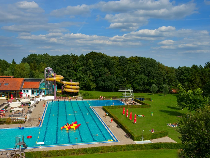 Luftaufnahme Hallen- und Freibad Wingst Luftaufnahme mit großem Außenbecken, Wasserrutsche, Liegewiese und umgebendem Grün in Wingst.