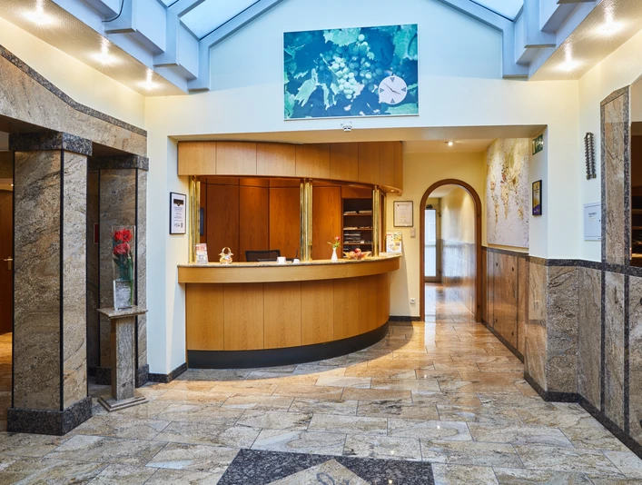 Hotel Zur Traube Garni Hotelrezeption in eleganter Lobby mit Marmorwänden und freundlichem Empfangsbereich.