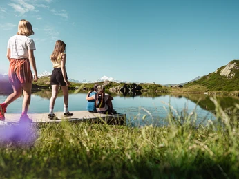 Families hiking on the Bettmeralp in the Aletsch Arena Families hiking on Bettmeralp in the Aletsch Arena