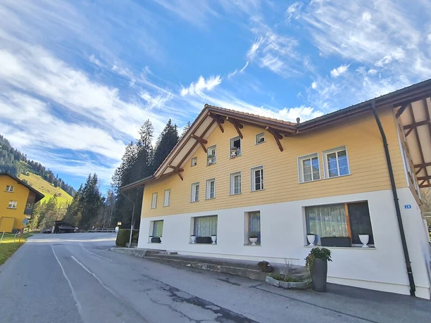 Gelb-weisses Haus an der Strasse gelegen