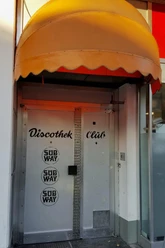 Subway Silver stainless steel door under a yellow awning, labeled "Discothek Club" and Subway logo.