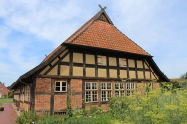 Dörverden Ehmken Hoff Fachwerkhaus in Dörverden mit roten Ziegeln, Sprossenfenstern und einem steilen Satteldach.