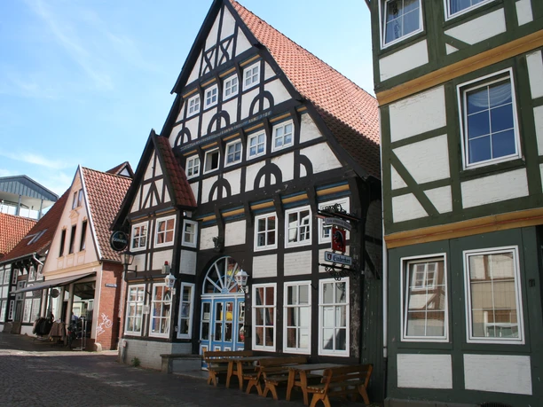 Half-timbered building with red tiled roofs, typical North German style, street scene in the sunshine.