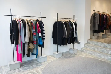 MATA Cologne Interior view of a fashion store with colorful and neutral garments on clothes rails.
