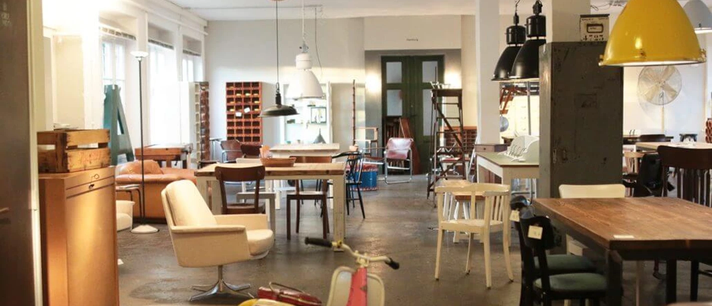 Geliebte Möbel A cozy vintage furniture store with colorful scooters, stylish lamps and wooden furniture.