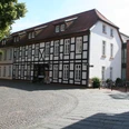 Stadtkontor Nienburg Fachwerkhaus in Nienburg mit rotem Satteldach und Kopfsteinpflaster im Vordergrund.