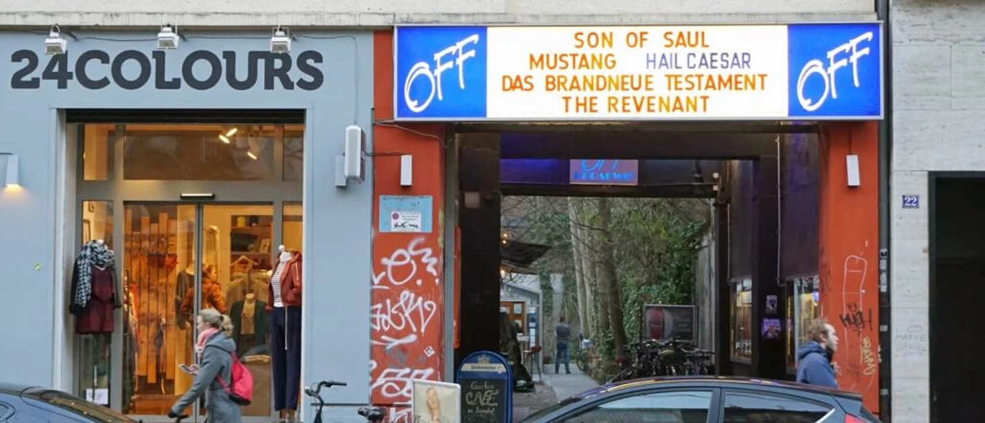 OFF Broadway Entrance to the OFF-Broadway cinema in Cologne, with passers-by and parked cars.