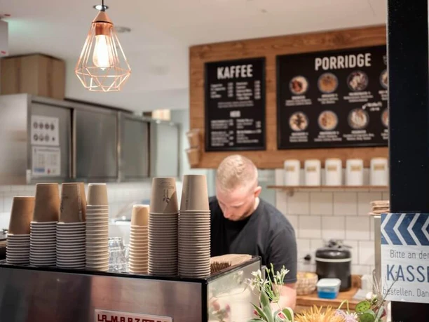 Haferkater Blick in das Bistro auf eine Espressomaschine und Kreidetafeln an der Wand.