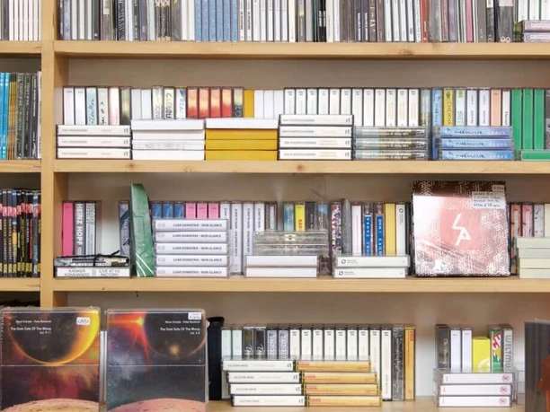 A-Musik Shelves with a variety of records and music cassettes in a record store.