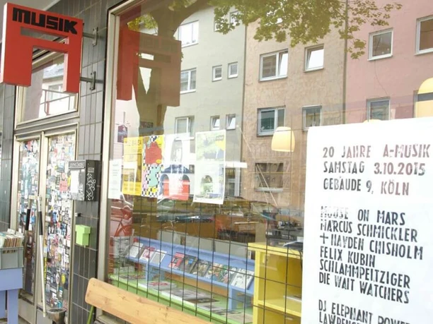 A-Musik The facade of a record store in Cologne shows a shop window with records and an event poster.
