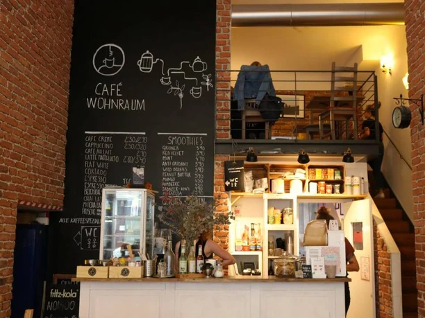 Wohnraum Café with brick walls, chalkboard menus, and an inviting, home-like atmosphere.