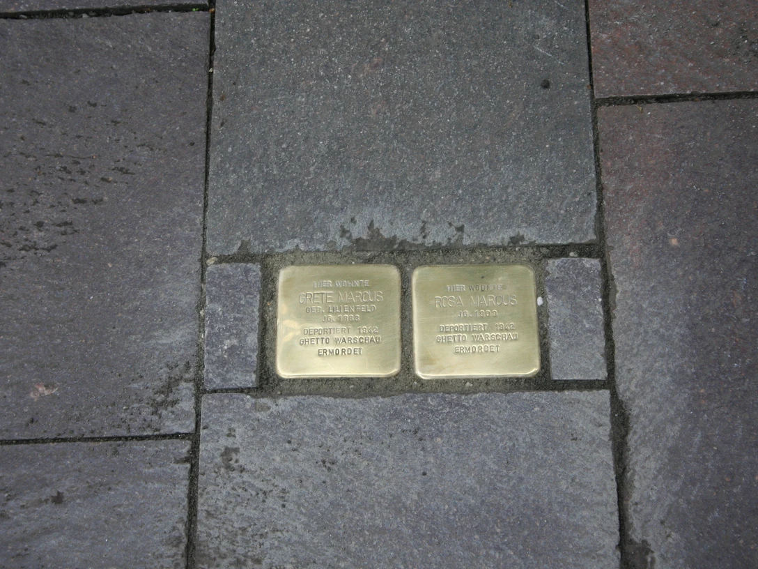 Stolpersteine Zwei Messingplatten inmitten von Bürgersteigpflaster gedenken Opfern des Nationalsozialismus.