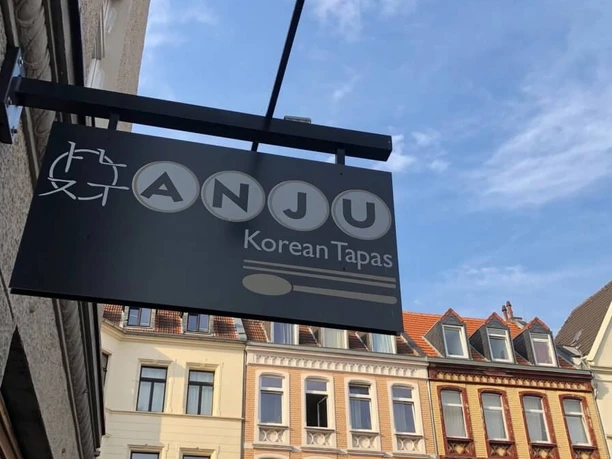 Restaurant Anju, sign View of a house facade with a restaurant sign.