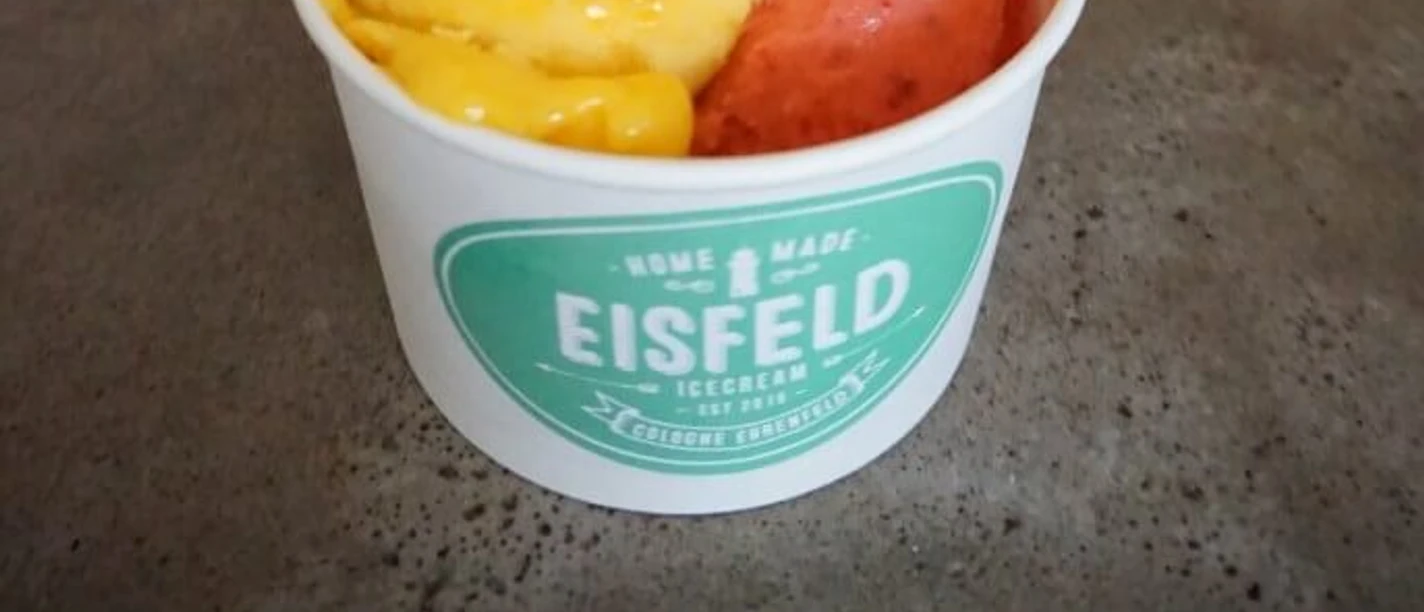 Eisfeld Two scoops of fruit ice cream with a cone in a cup.