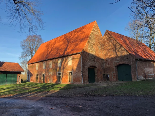 Kloster Schinna 2020 Oud bakstenen kloostergebouw met een hoog rood dak, omringd door kale bomen.