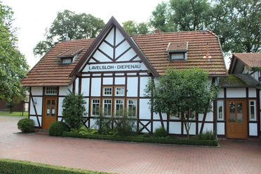 Hochzeitsbahnhof Lavelsloh Historic half-timbered Lavelsloh station with red roof tiles and two symmetrical entrance doors.