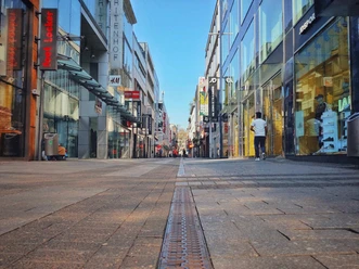 Hohe Straße Hohe Strasse in Cologne is a busy shopping street with modern glass facades and people.