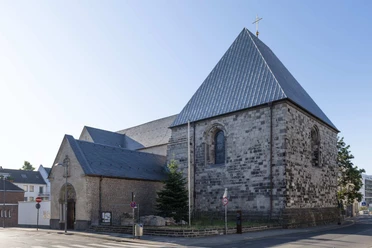 St. George Romanesque church of St. George with natural stone façade and steep pitched roof in daylight.