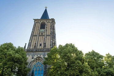 Saint Severin Historic church of St. Severin with a magnificent clock tower, surrounded by green treetops.