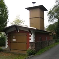 Altes Spritzenhaus in Extertal-Almena Historisches Feuerwehrhaus mit rotem Ziegelbau und Holzaufbau in Extertal-Almena, umgeben von Bäumen.