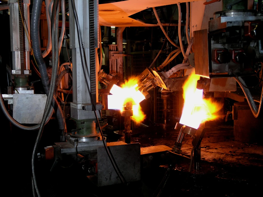 Flammen erhitzen Glas in einer industriellen Produktionsumgebung bei der Glasherstellung.