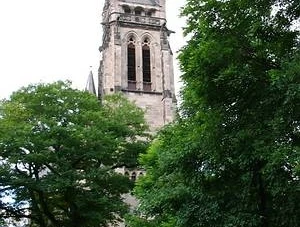 Christuskirche Neugotische Christuskirche umgeben von Bäumen, markanter Turm und grüne Parkanlage.